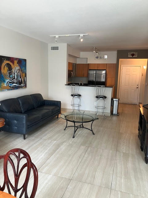 802 West Windward Way, Unit 204 Lantana, FL 33462 - Photo 8 of 29 a living room with furniture and a flat screen tv