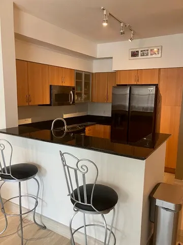 a kitchen with a table and chairs