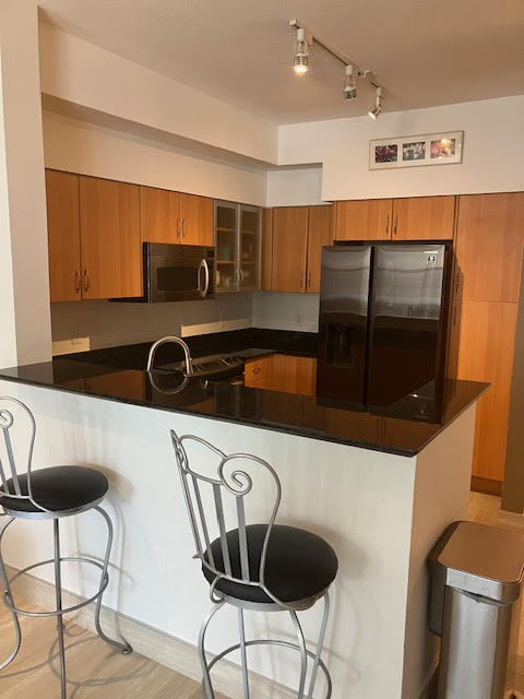 802 West Windward Way, Unit 204 Lantana, FL 33462 - Photo 9 of 29 a kitchen with a table and chairs