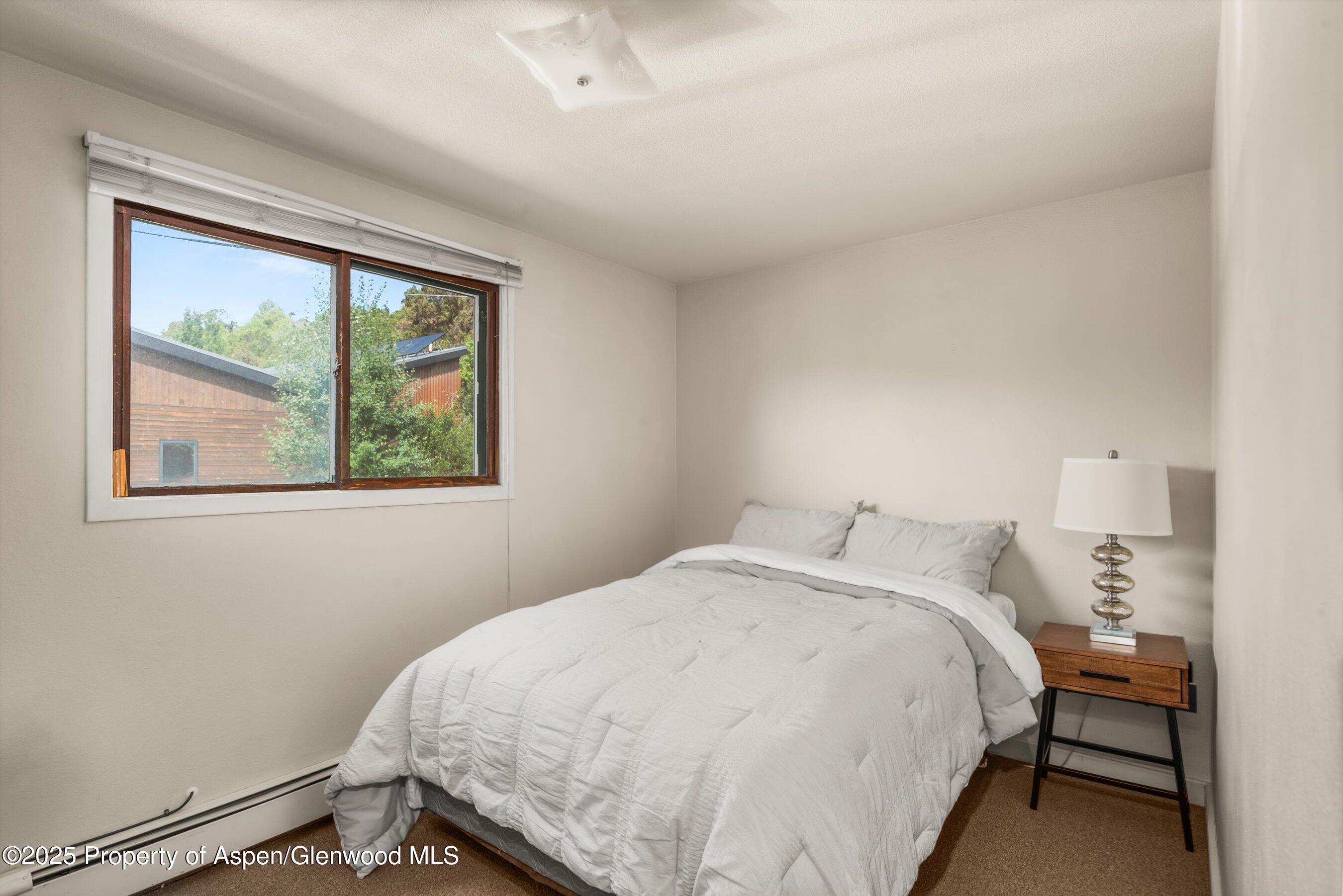 112 Hillside Drive Basalt, CO 81621 - Photo 11 of 28 a bedroom with a bed and a window
