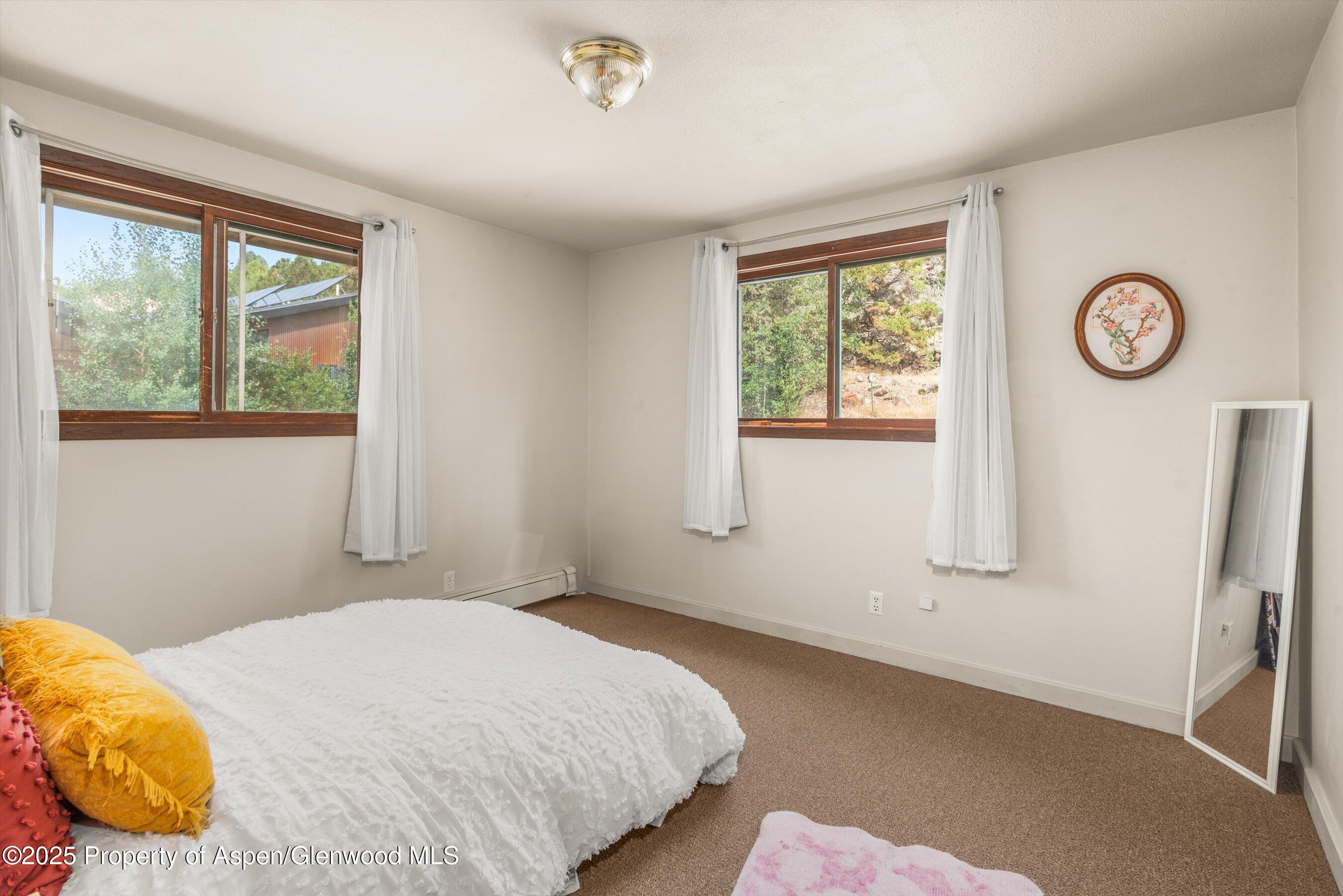 112 Hillside Drive Basalt, CO 81621 - Photo 13 of 28 a bedroom with a bed and a window