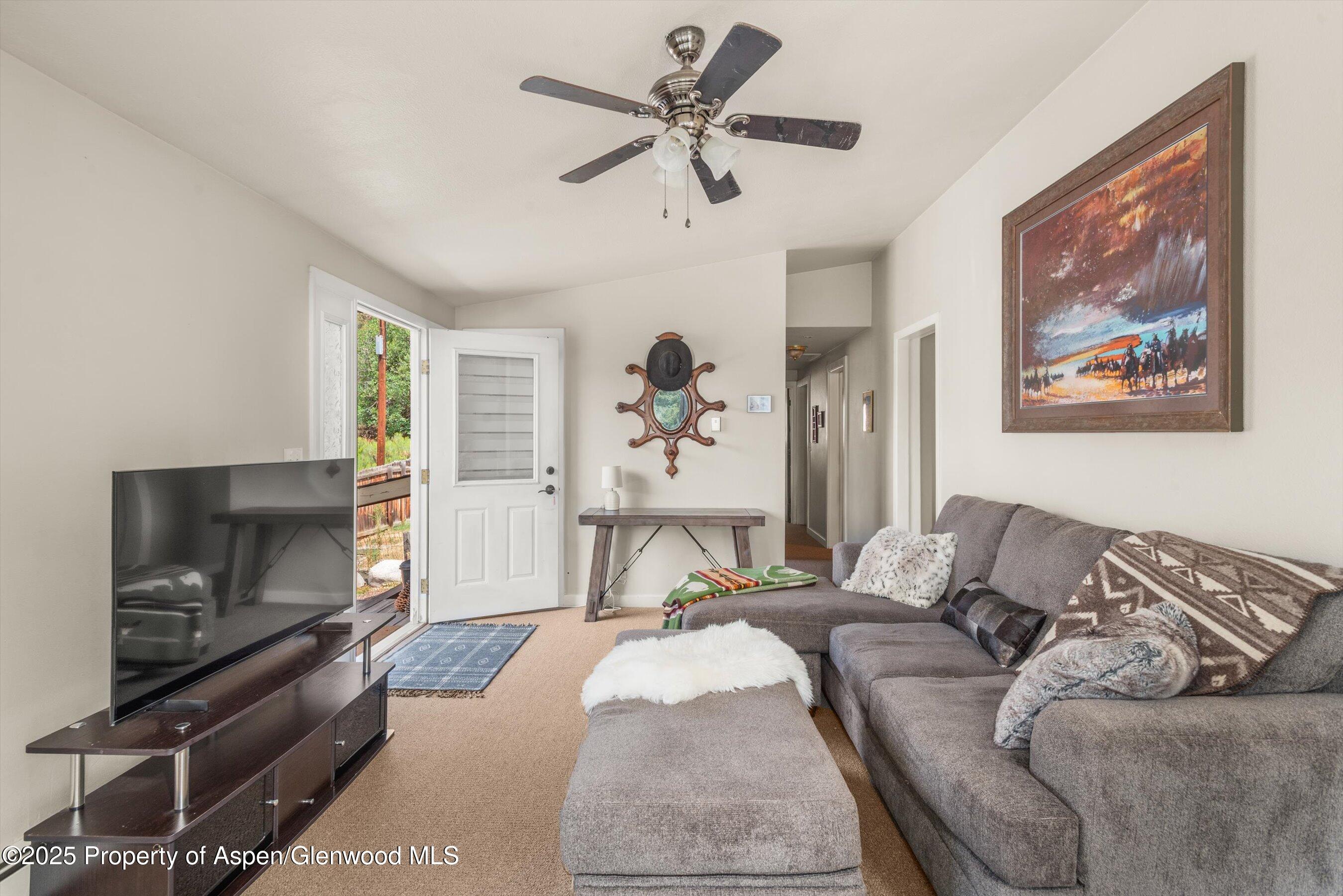 112 Hillside Drive Basalt, CO 81621 - Photo 3 of 28 a living room with furniture and a flat screen tv