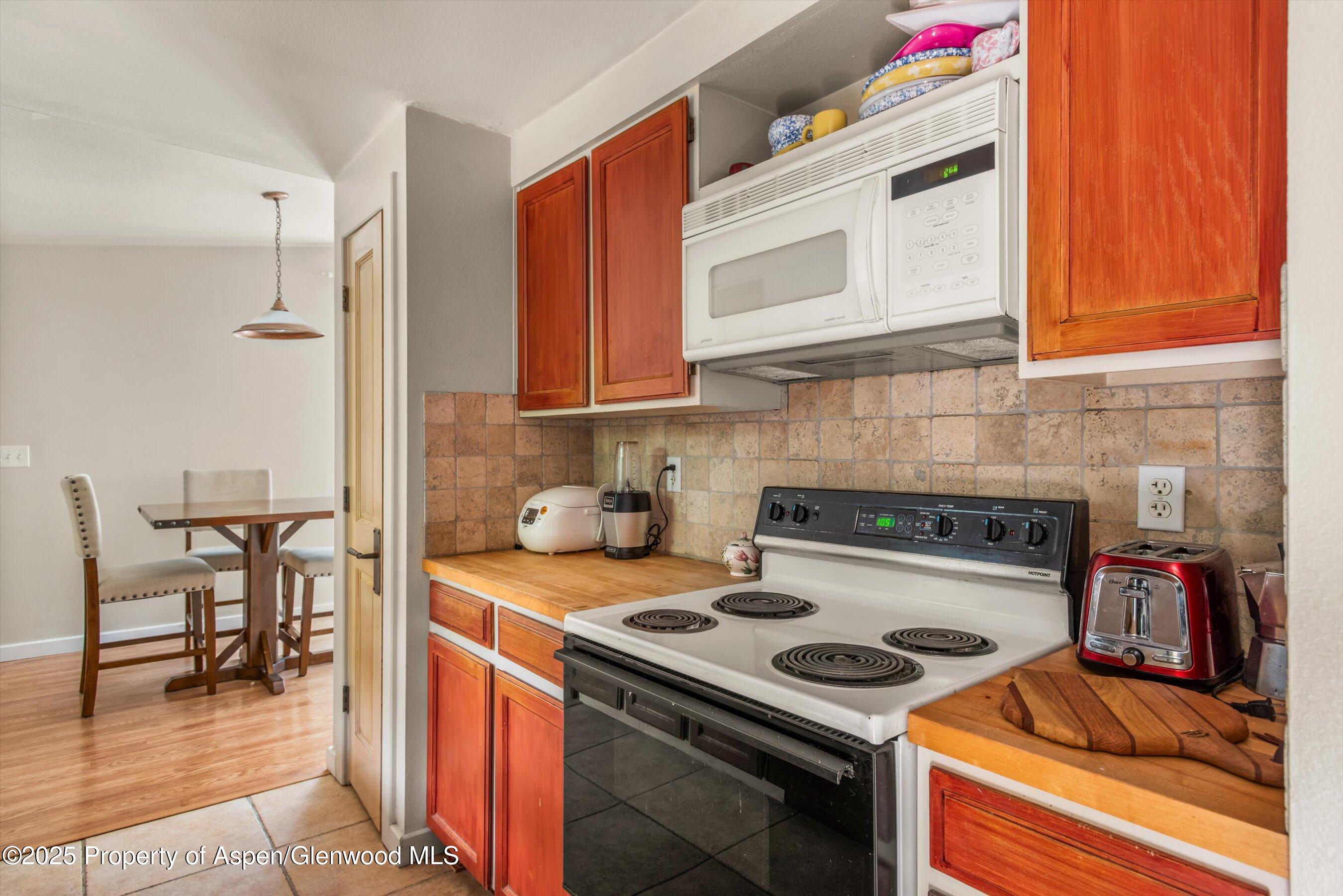 112 Hillside Drive Basalt, CO 81621 - Photo 7 of 28 a kitchen with a stove and a microwave