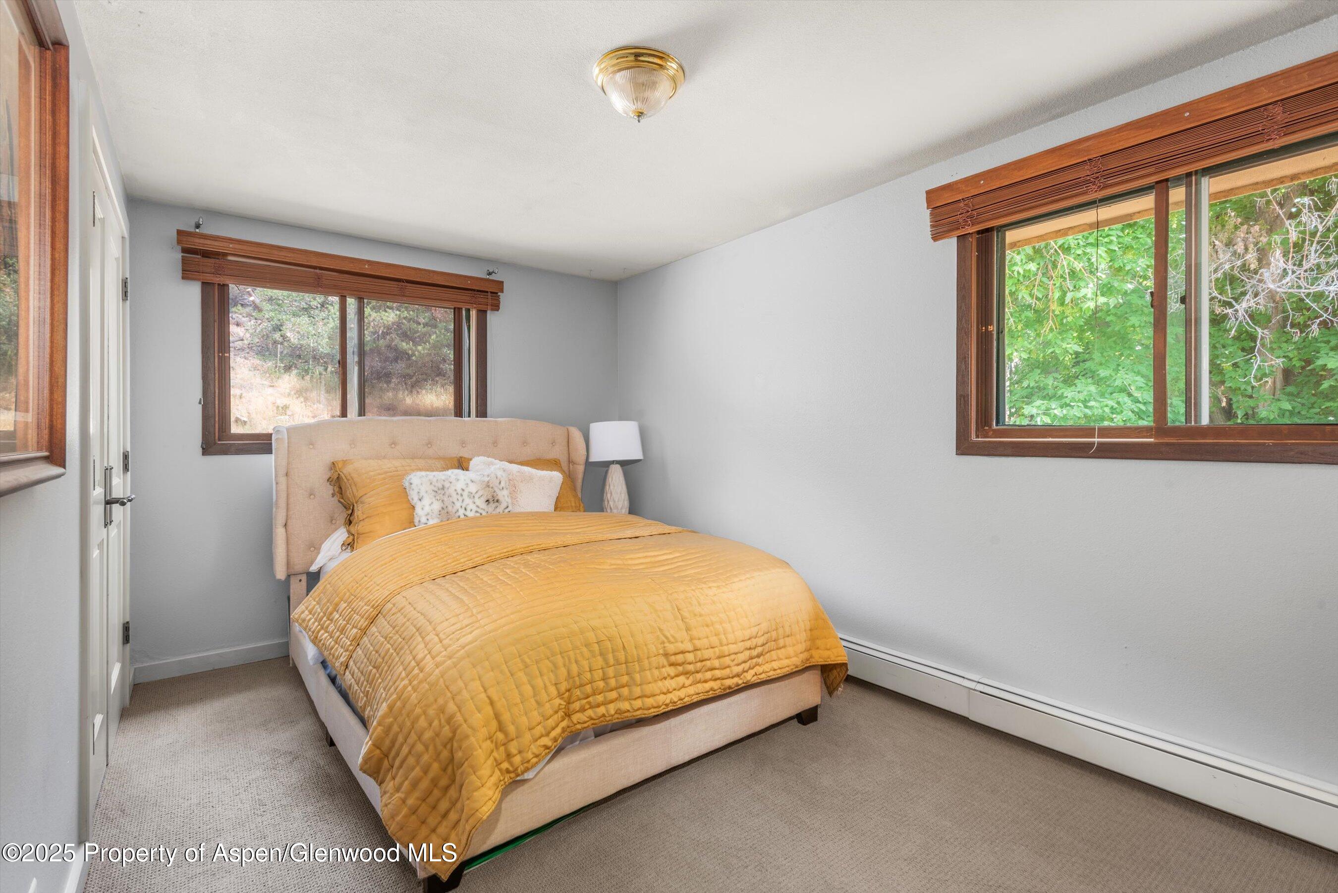 112 Hillside Drive Basalt, CO 81621 - Photo 9 of 28 a bed sitting in a bedroom next to a window