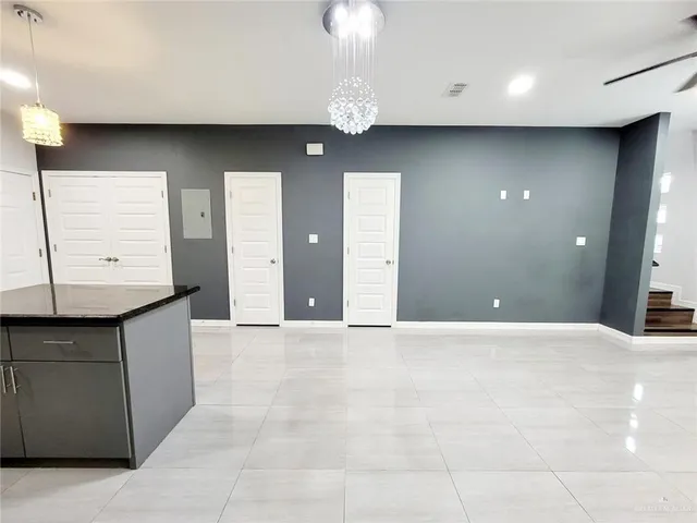 a view of kitchen with microwave and cabinets