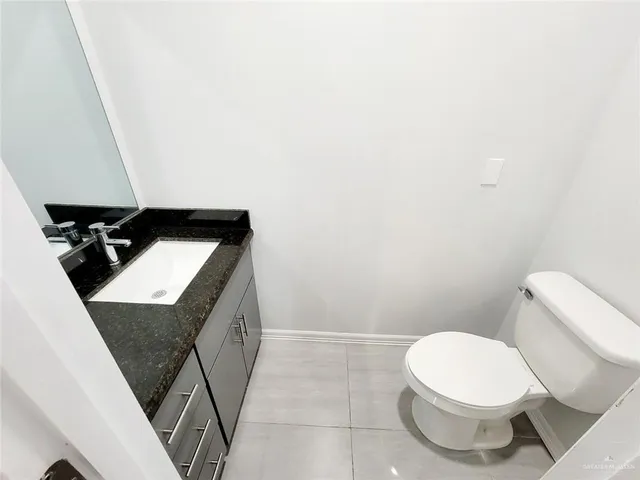 a bathroom with a toilet a sink and shower