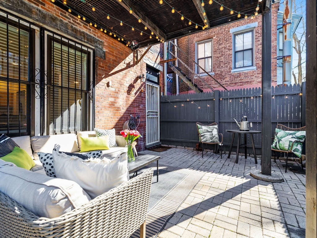 37 East Springfield Street, Unit 1 Boston, MA 02118 - Photo 15 of 18 a view of a patio with couches chairs and potted plants