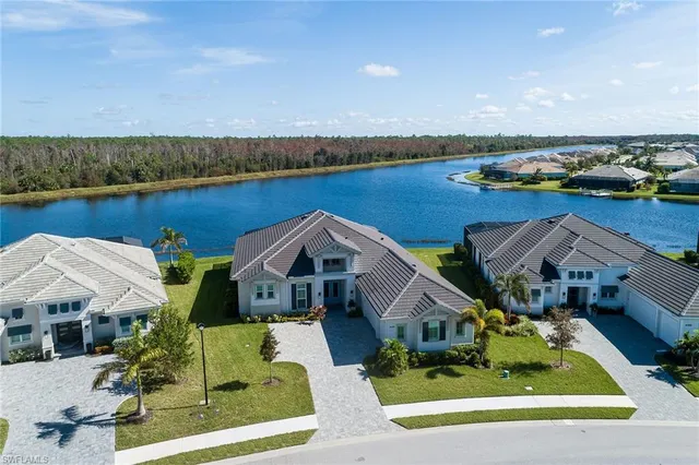 an aerial view of a house with swimming pool garden and patio