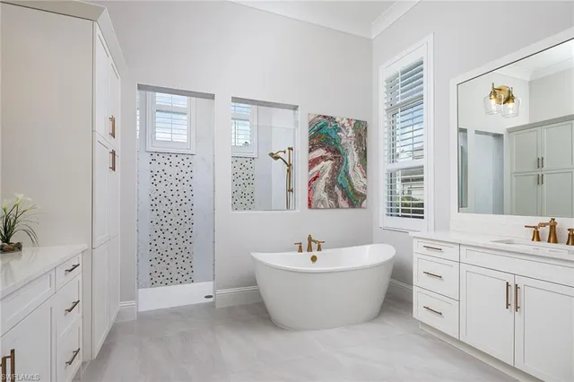 a view of bathroom with bathtub mirror and sink