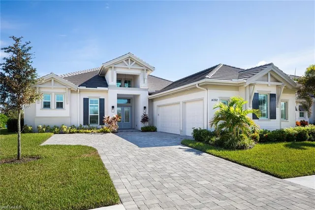 a front view of multiple houses with yard
