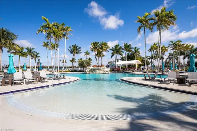 a view of a swimming pool with outdoor seating