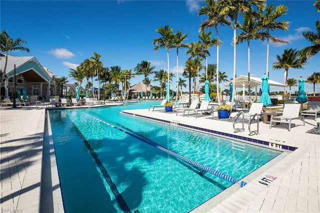 a swimming pool with outdoor seating and yard
