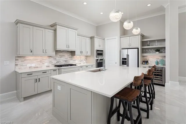 a kitchen with a white cabinets and chairs