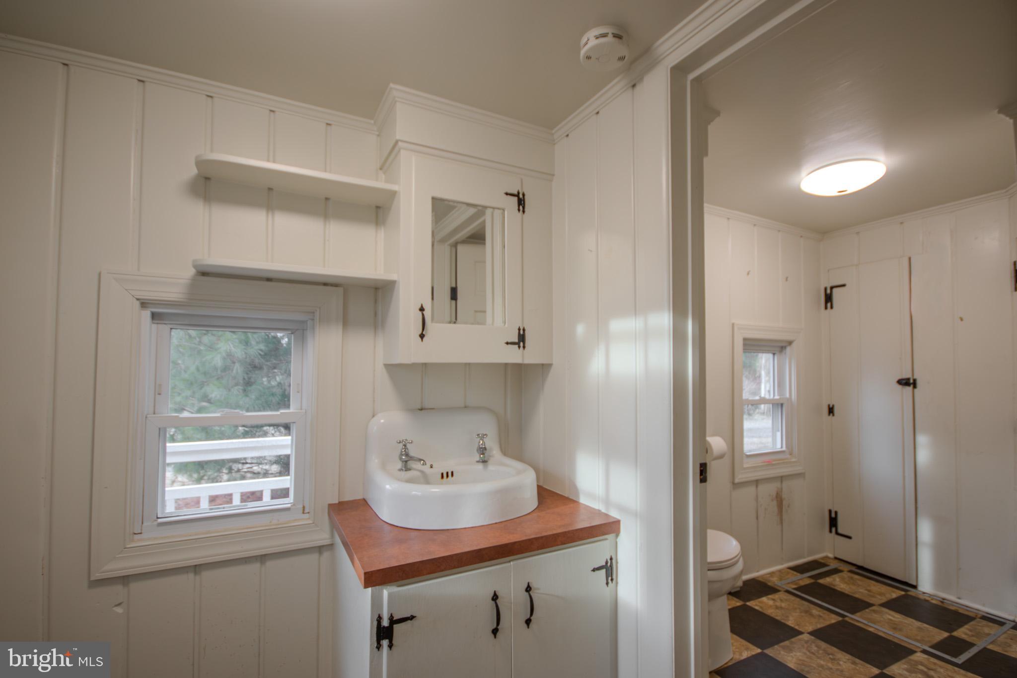 6817 Quantico Road Hebron, MD 21830 - Photo 13 of 39 a bathroom with a sink and a window