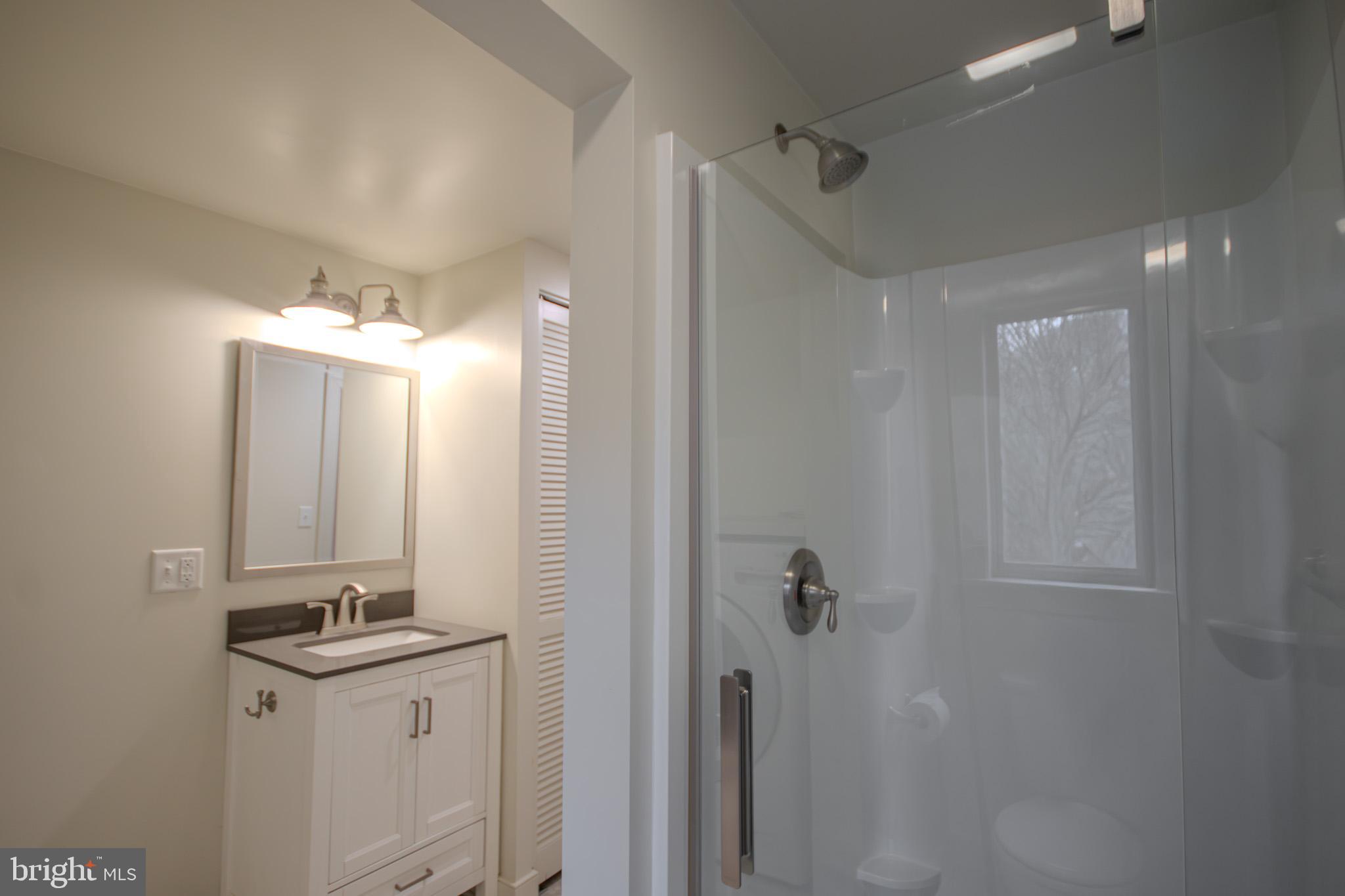 6817 Quantico Road Hebron, MD 21830 - Photo 18 of 39 a bathroom with a sink vanity and a mirror