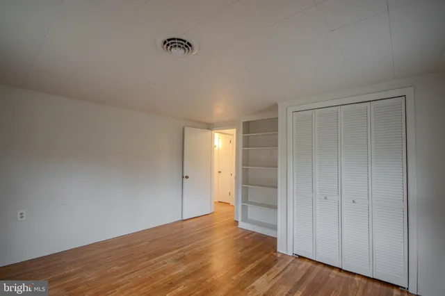 a view of an empty room and wooden floor