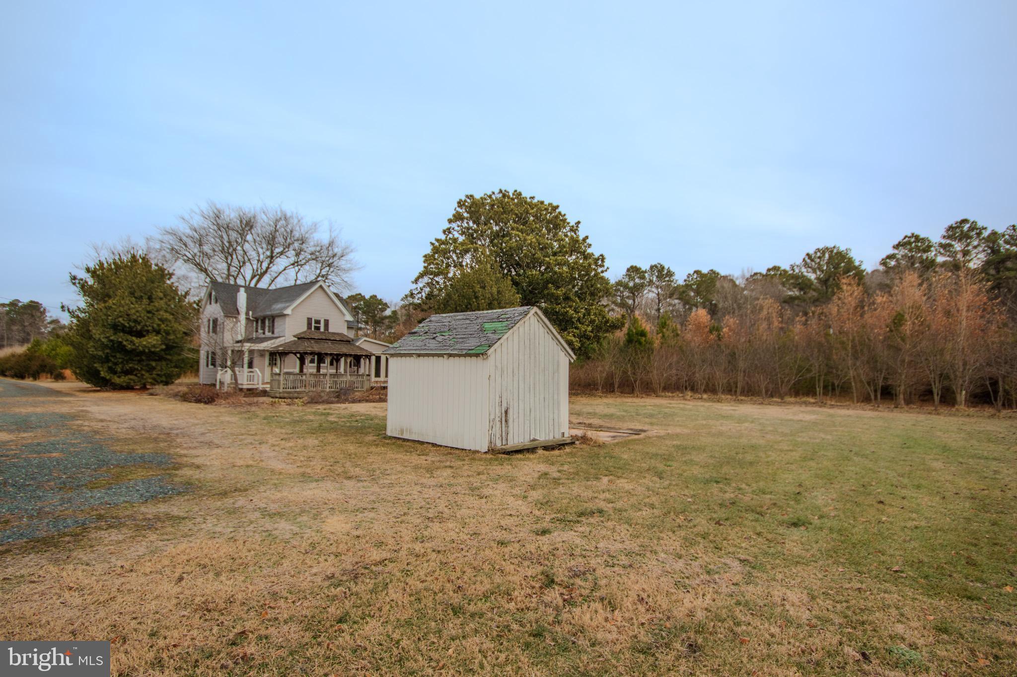 6817 Quantico Road Hebron, MD 21830 - Photo 33 of 39 a view of a big house with a big yard and large trees