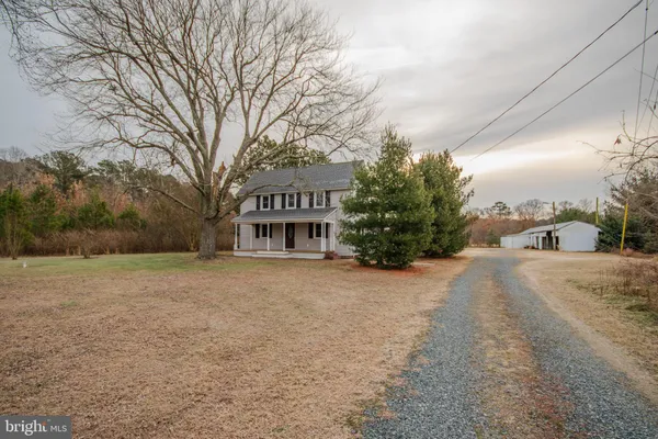a view of a house with a yard and garage