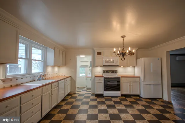 a kitchen with granite countertop stainless steel appliances a sink and cabinets