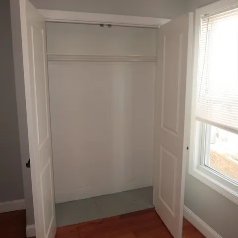 a white toilet sitting next to a window