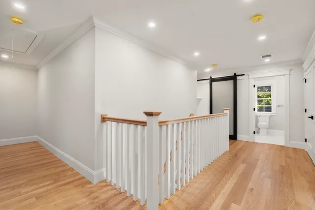 a view of hallway with wooden floor