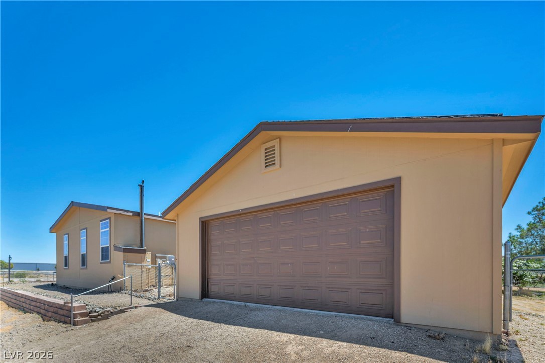 225 California Street Searchlight, NV 89046 - Photo 10 of 64 A spacious garage provides ample storage and parking solutions on a bright day.