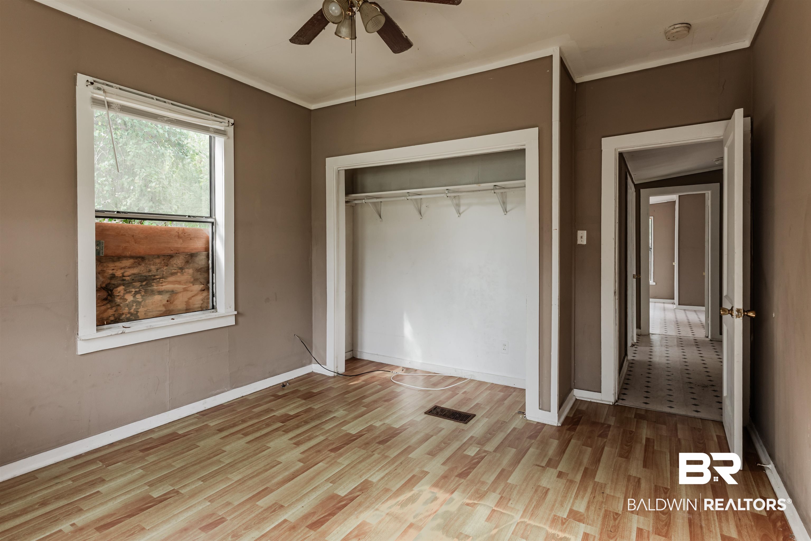 600 Mohawk Street Mobile, AL 36606 - Photo 18 of 20 Unfurnished bedroom with ornamental molding, ceiling fan, light hardwood / wood-style floors, and a closet