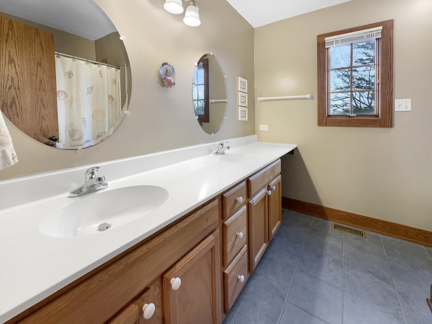 493 Aberdeen Drive Crete, IL 60417 - Photo 35 of 52 a bathroom with a double vanity sink and a mirror