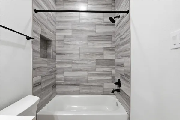 a kitchen with kitchen island stainless steel appliances a sink a stove a counter space and a window