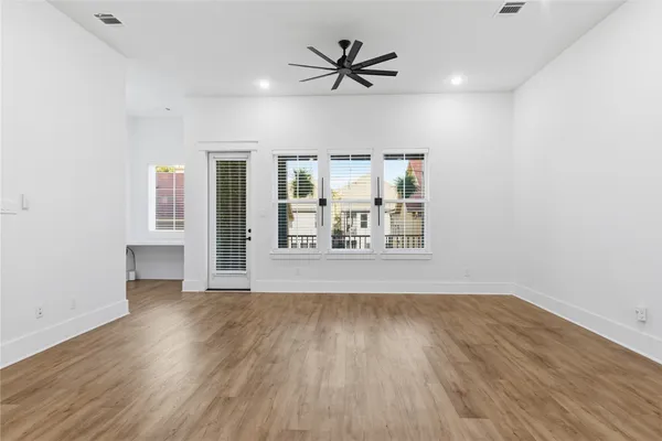 a kitchen with kitchen island a counter space a sink appliances and a window