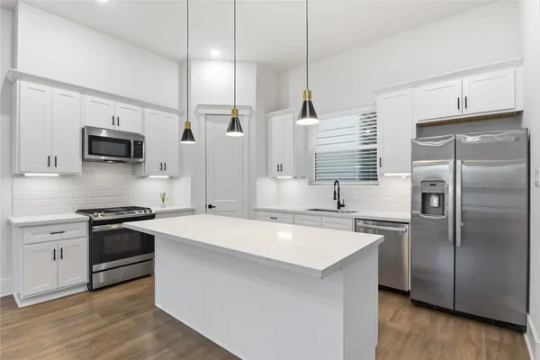 a view of a room with wooden floor and windows
