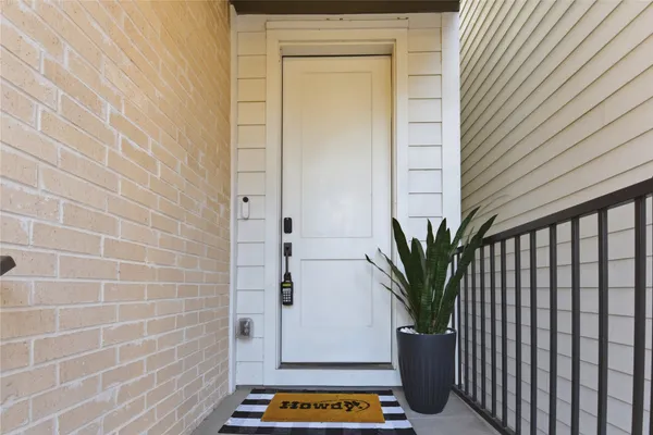 an empty room with wooden floor and a ceiling fan