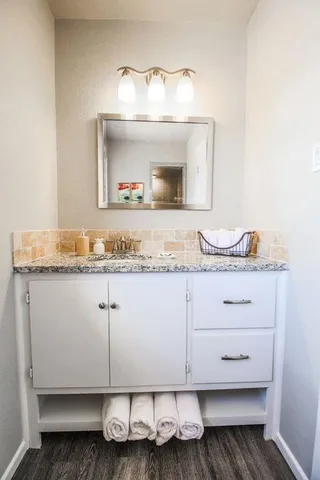 a bathroom with a sink and a mirror