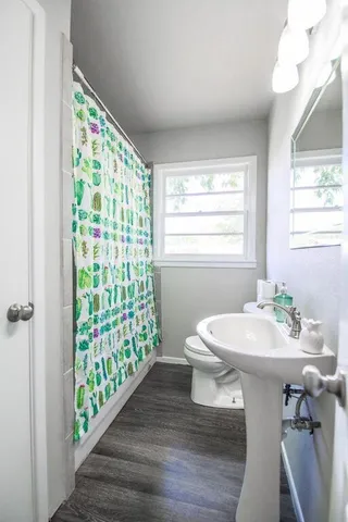 a bathroom with a sink mirror and a window