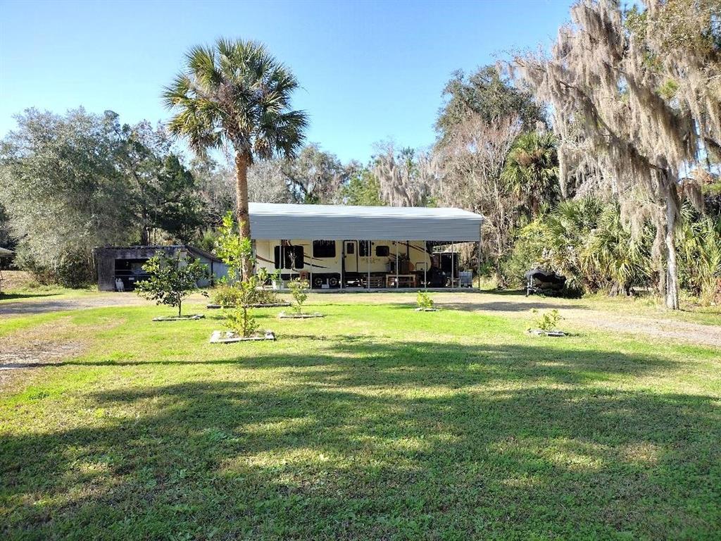 188 Canham Street Bunnell, FL 32110 - Photo 2 of 4 a view of swimming pool with lawn chairs and plants