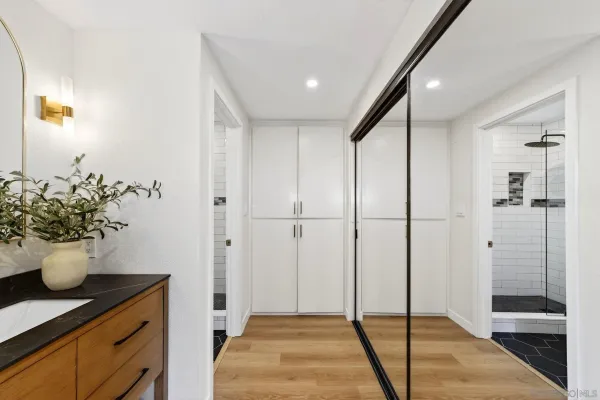 a view of a hallway with wooden shelves