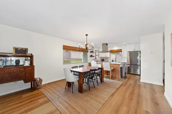 a dining room with furniture a rug and wooden floor