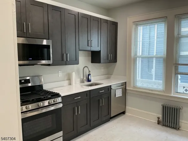 a kitchen with wooden cabinets and a stove top oven