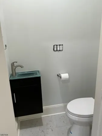 a bathroom with a sink a toilet and mirror