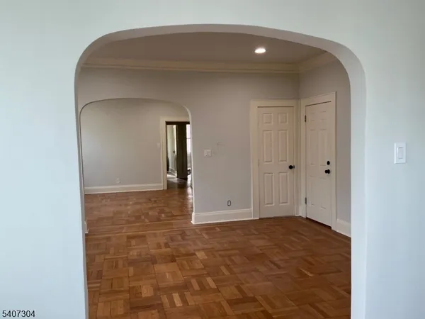 a front view of a building and car parked