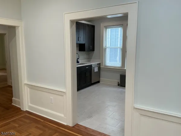 a view of a hallway and an dining rom with furniture