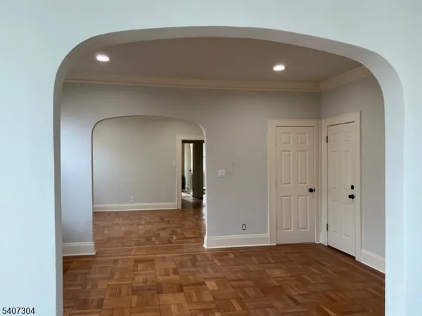 a view of a hallway with wooden floor