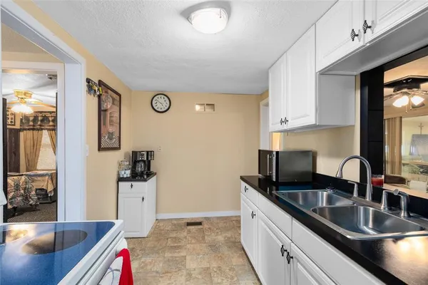 a kitchen with stainless steel appliances granite countertop a sink and cabinets