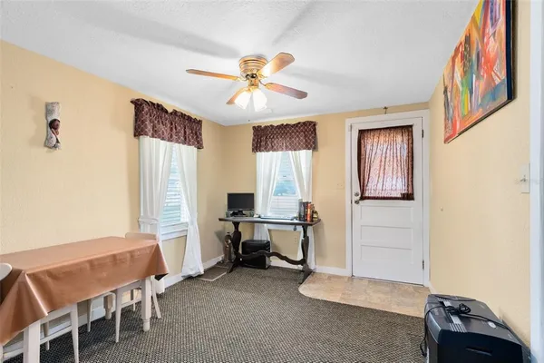 a view of a workspace with furniture and a window