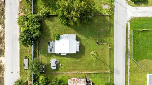 an aerial view of a residential houses with outdoor space