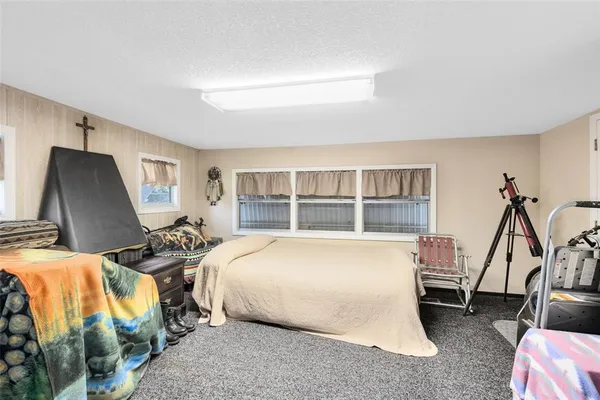 a bedroom with bed and a window