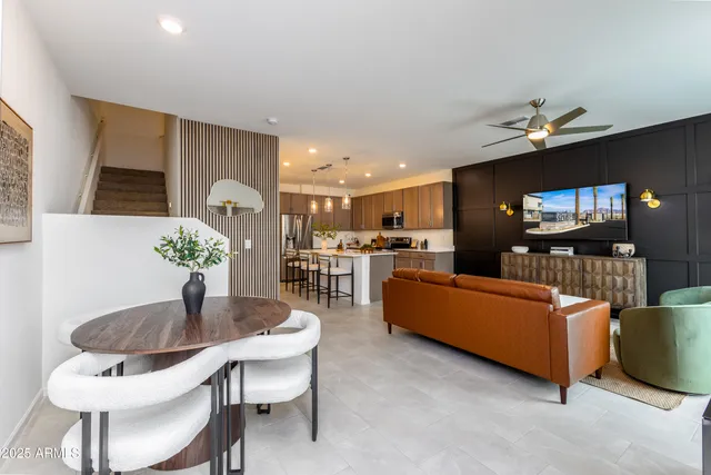 a living room with furniture and kitchen view