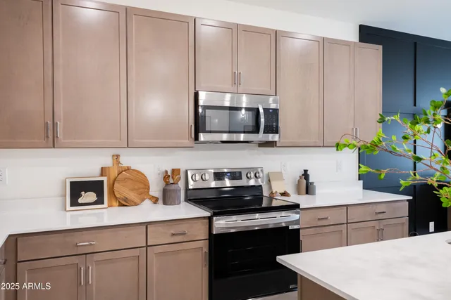 a kitchen with stainless steel appliances a sink cabinets and a microwave
