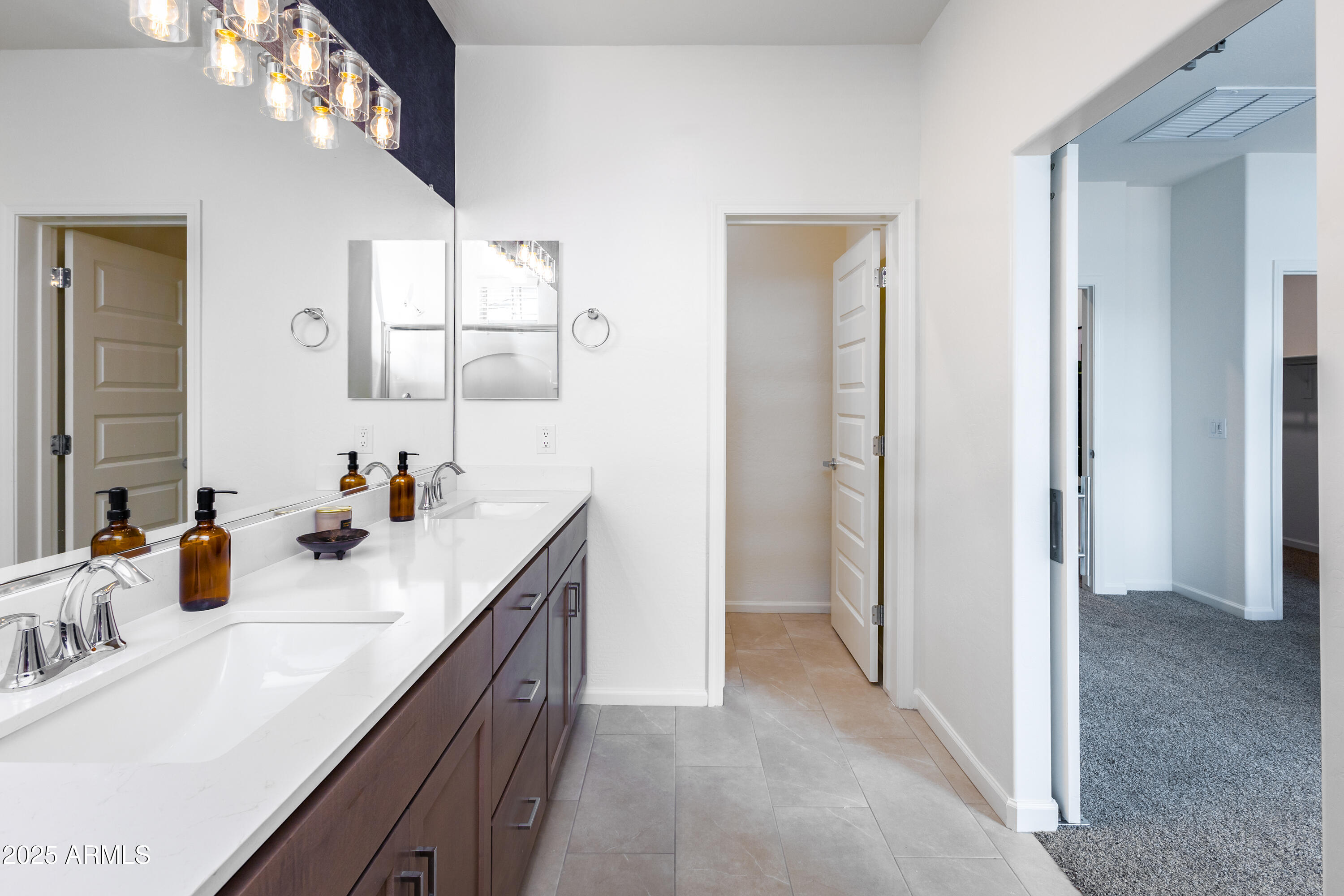 651 North Ironwood Drive, Unit 3 Apache Junction, AZ 85120 - Photo 35 of 48 a bathroom with a sink vanity and mirror