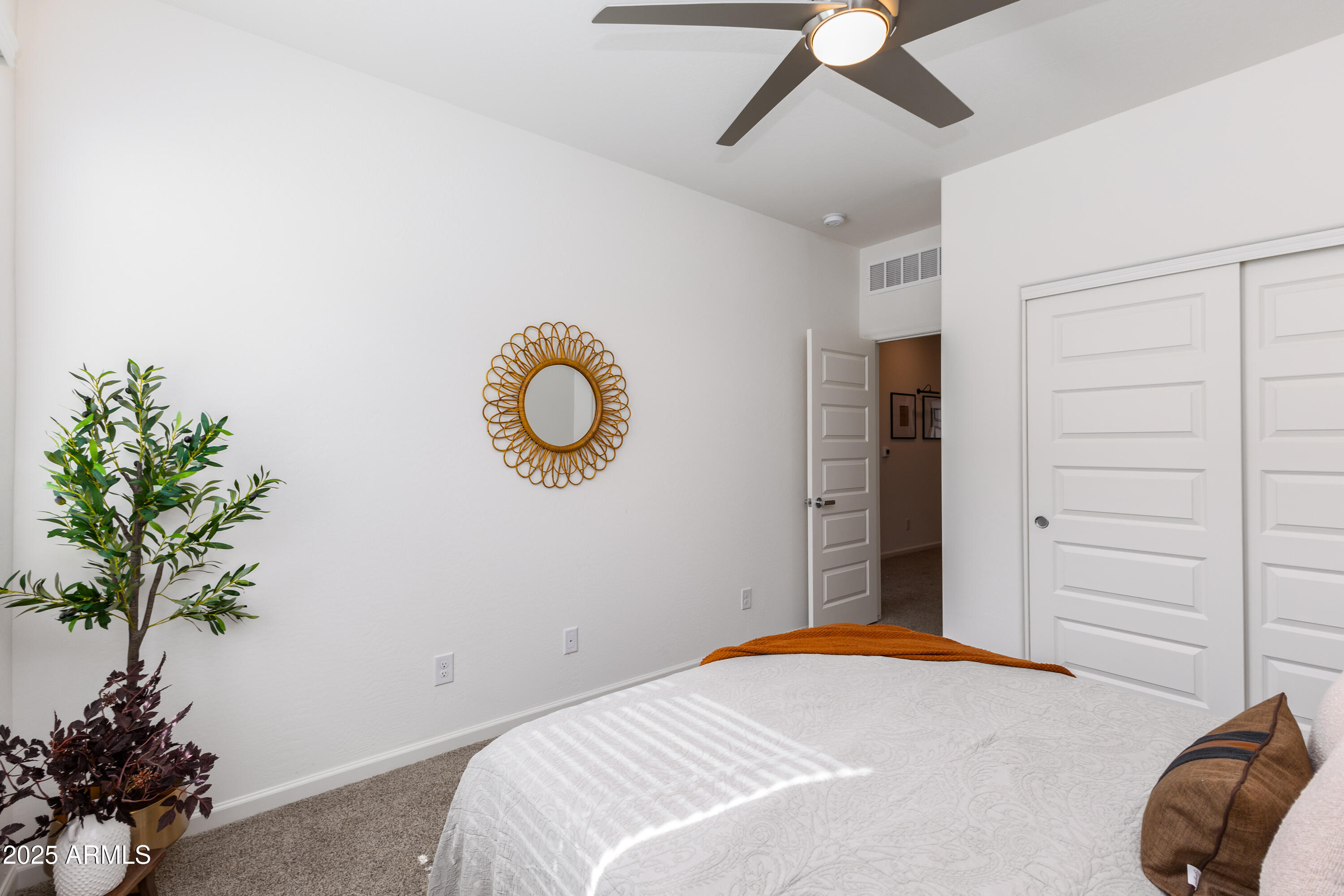 651 North Ironwood Drive, Unit 3 Apache Junction, AZ 85120 - Photo 38 of 48 a bedroom with a bed and a potted plant